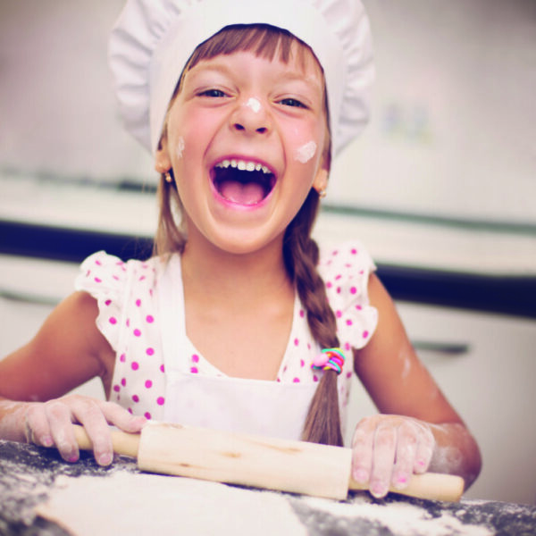 Cooking is fun. Little girl playing with flour